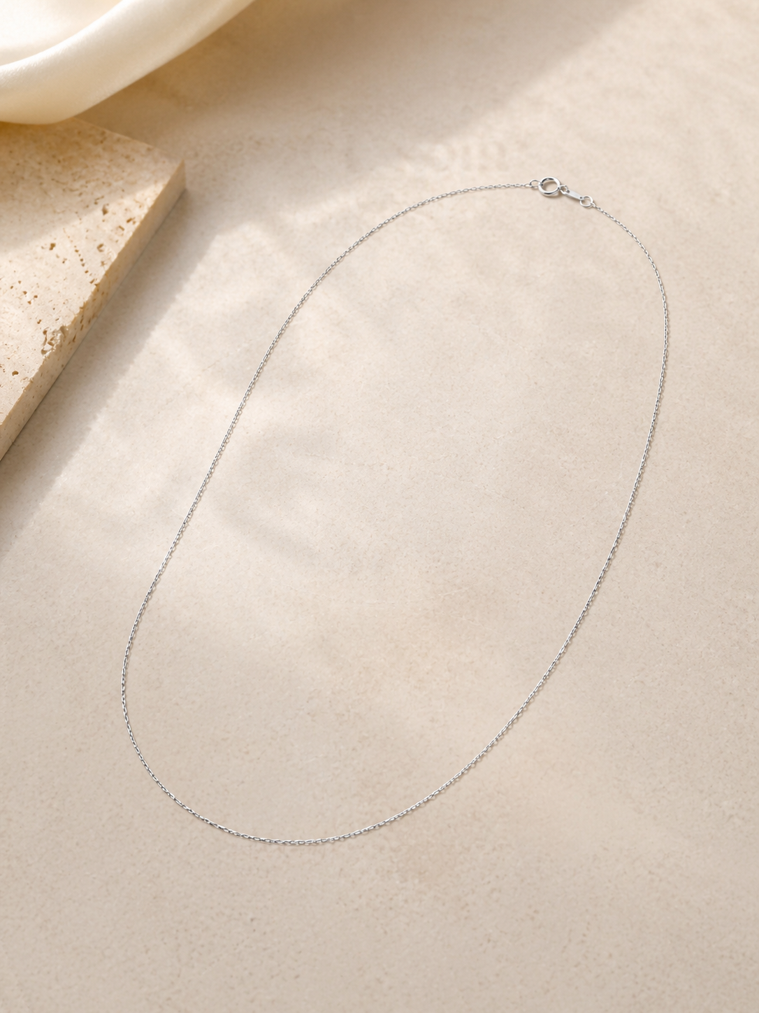 CARV. silver single chain necklace displayed flat with a fine minimalist chain and clasp detail