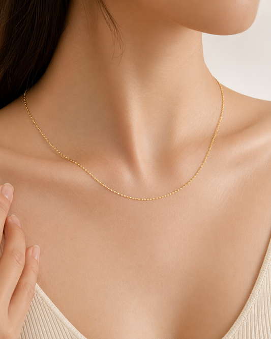 CARV. gold minimalist single chain necklace worn at collarbone with fine chain detail