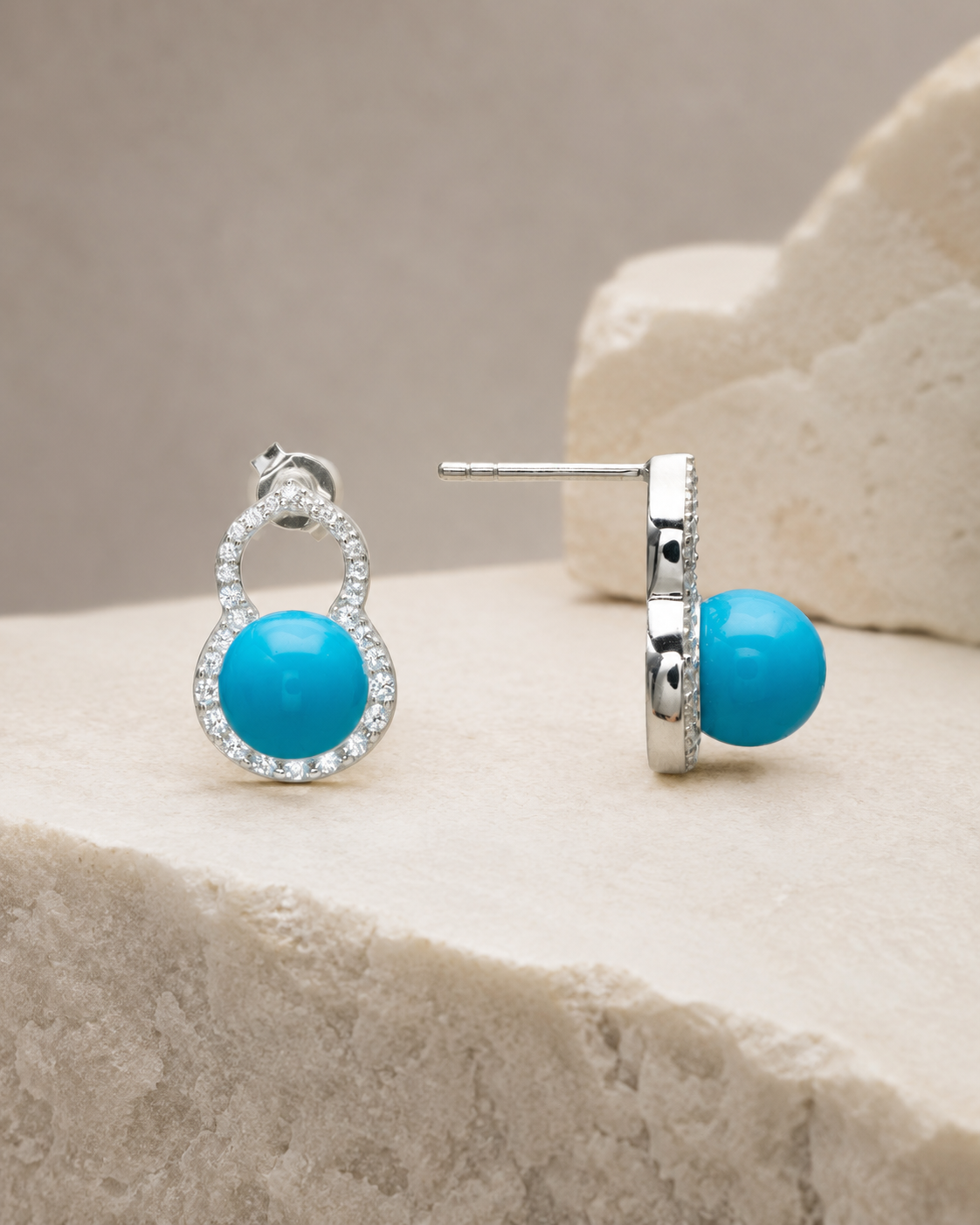 CARV. silver turquoise halo stud earrings with round blue stones and pavé setting on stone display