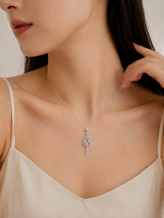 CARV. silver crystal cage pendant necklace worn at collarbone with teardrop filigree pendant