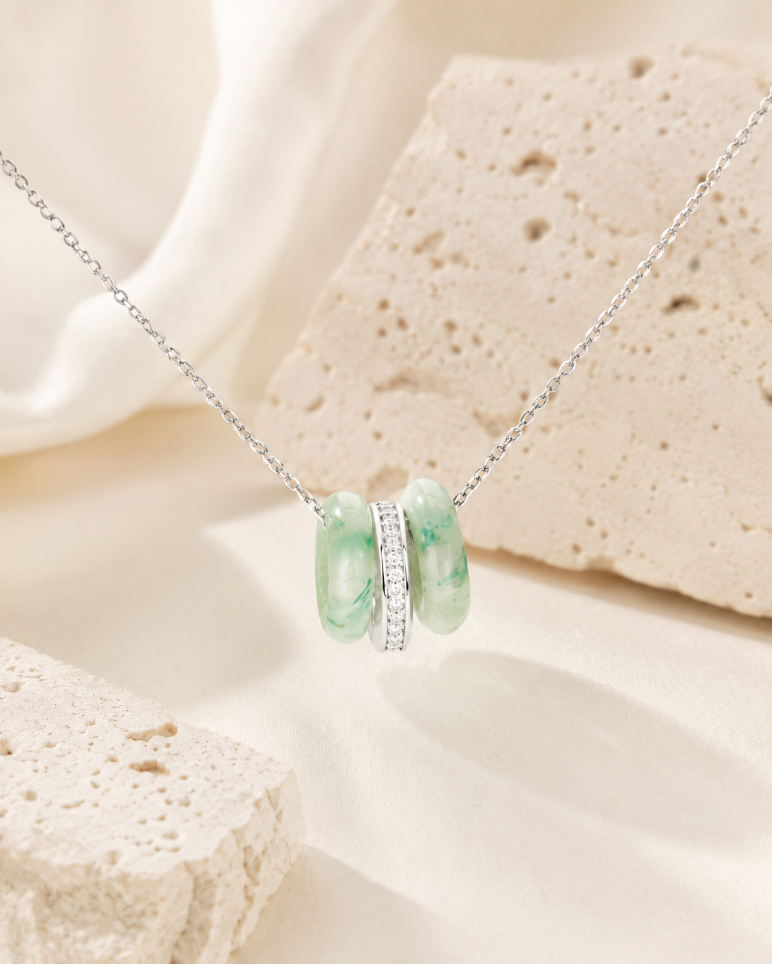 CARV. silver green stone orbit pendant necklace with triple hoop pendant on product display