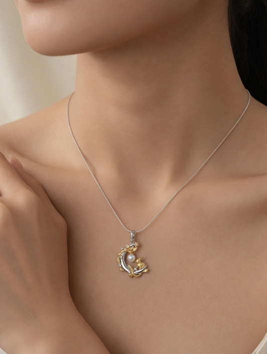 CARV. two-tone moon rabbit pearl pendant necklace with silver crescent moon, gold rabbit detail and white pearl charm worn on neck