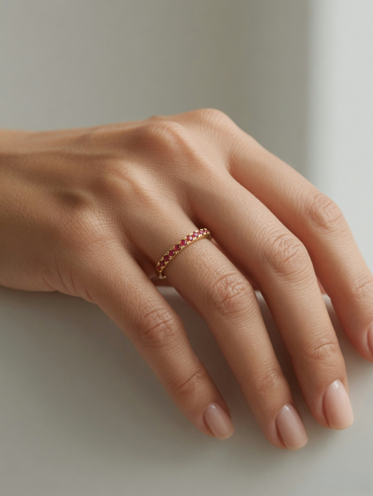 CARV. gold red stone band ring worn on hand with slim band and red stone setting