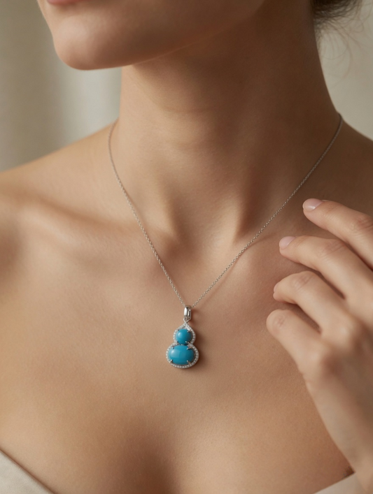 CARV. silver turquoise gourd pendant necklace worn at collarbone with fine chain detail