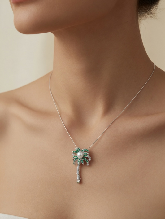 CARV. silver palm tree pendant necklace with pearl center and green stone leaves worn on neck