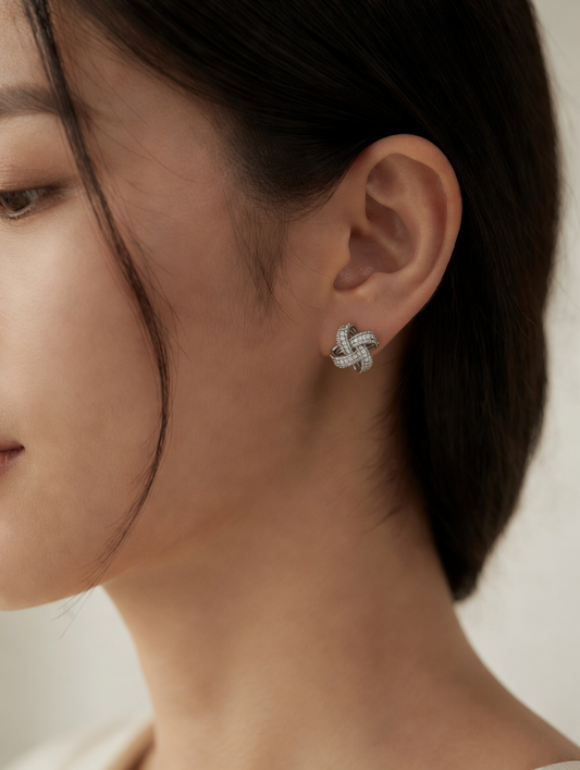 CARV. silver pavé loop stud earrings with layered curved bands worn on ear