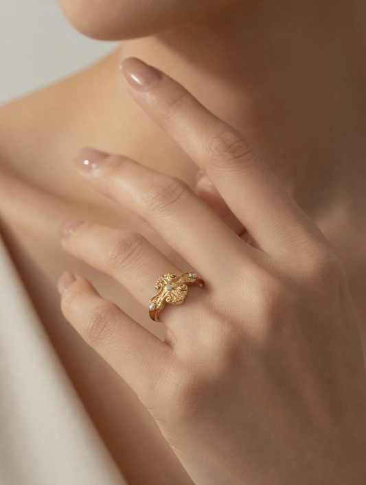 CARV. gold vine ring worn on hand with pavé detail and curved leaf design