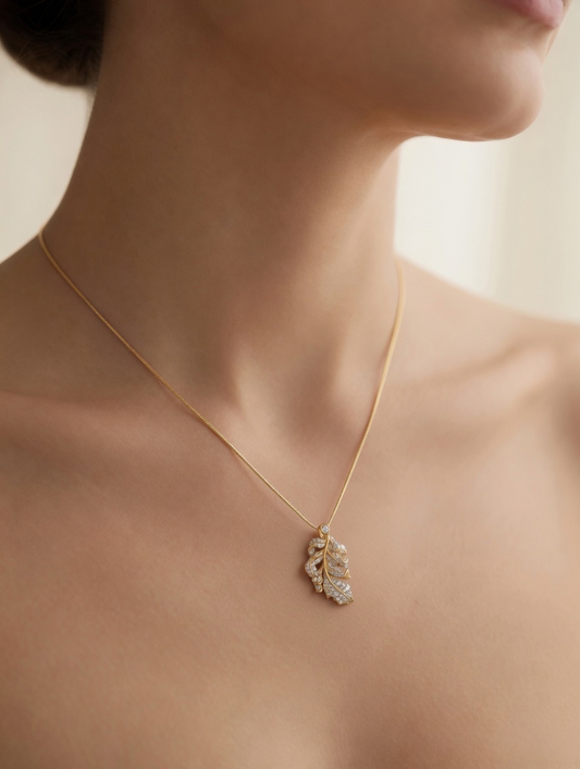 CARV. gold leaf pendant necklace with pavé crystals worn at neckline close-up