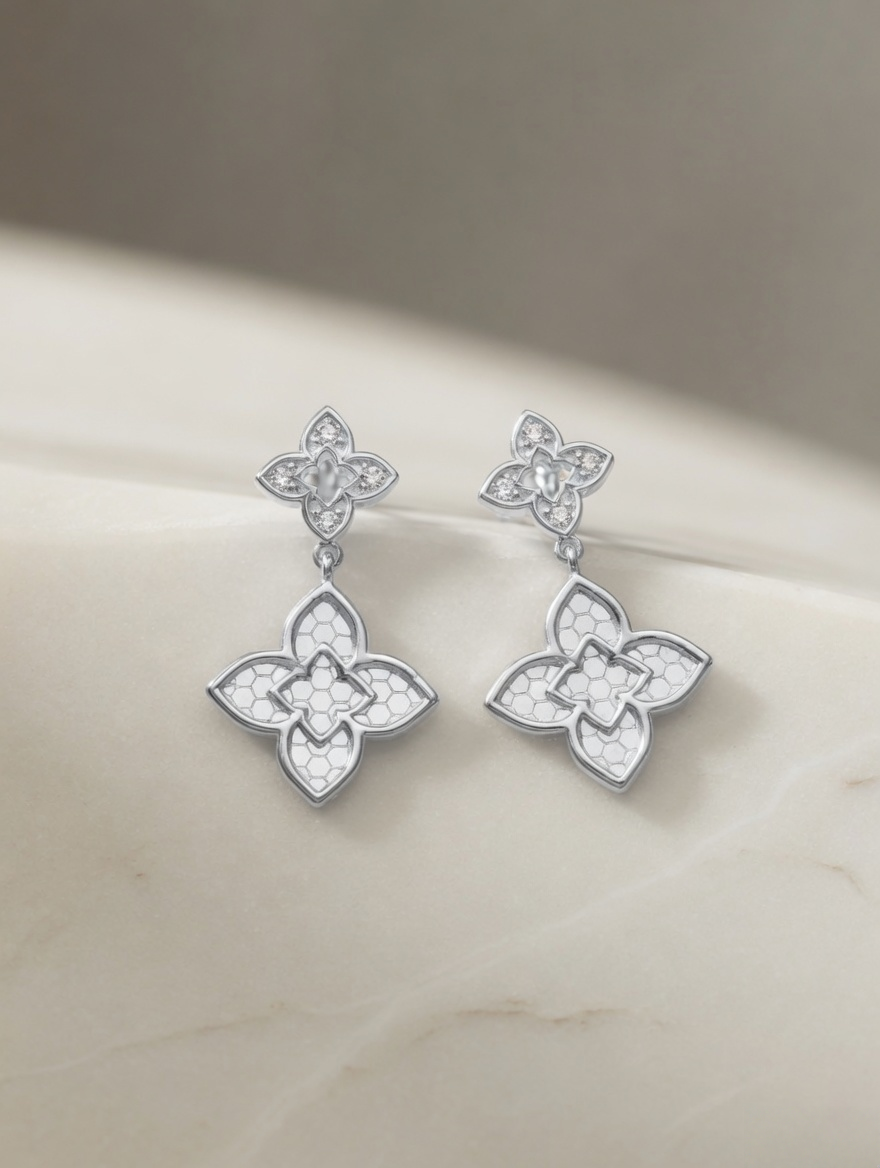 CARV. silver clover drop earrings with ornate quatrefoil design on display