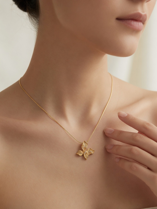 CARV. gold leaf pendant necklace worn at collarbone with four-leaf pendant and pavé detail
