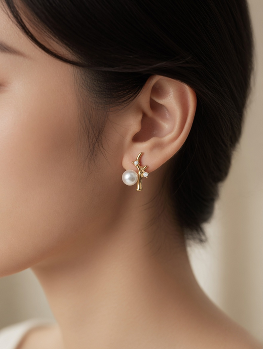 CARV. gold pearl branch stud earrings with white pearl and crystal accents worn on ear