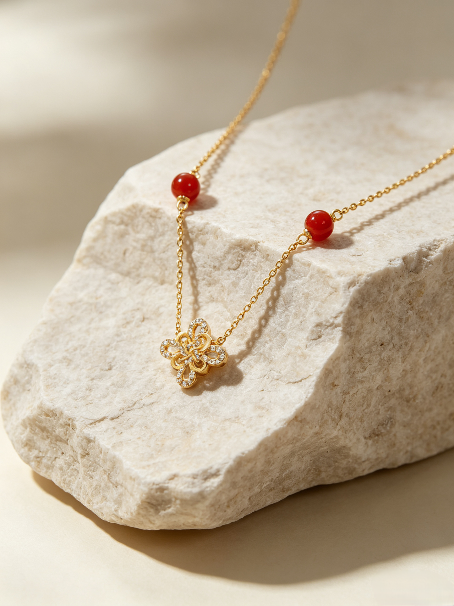 CARV. gold red agate knot necklace with red bead stations, fine chain and gold knot pendant detail
