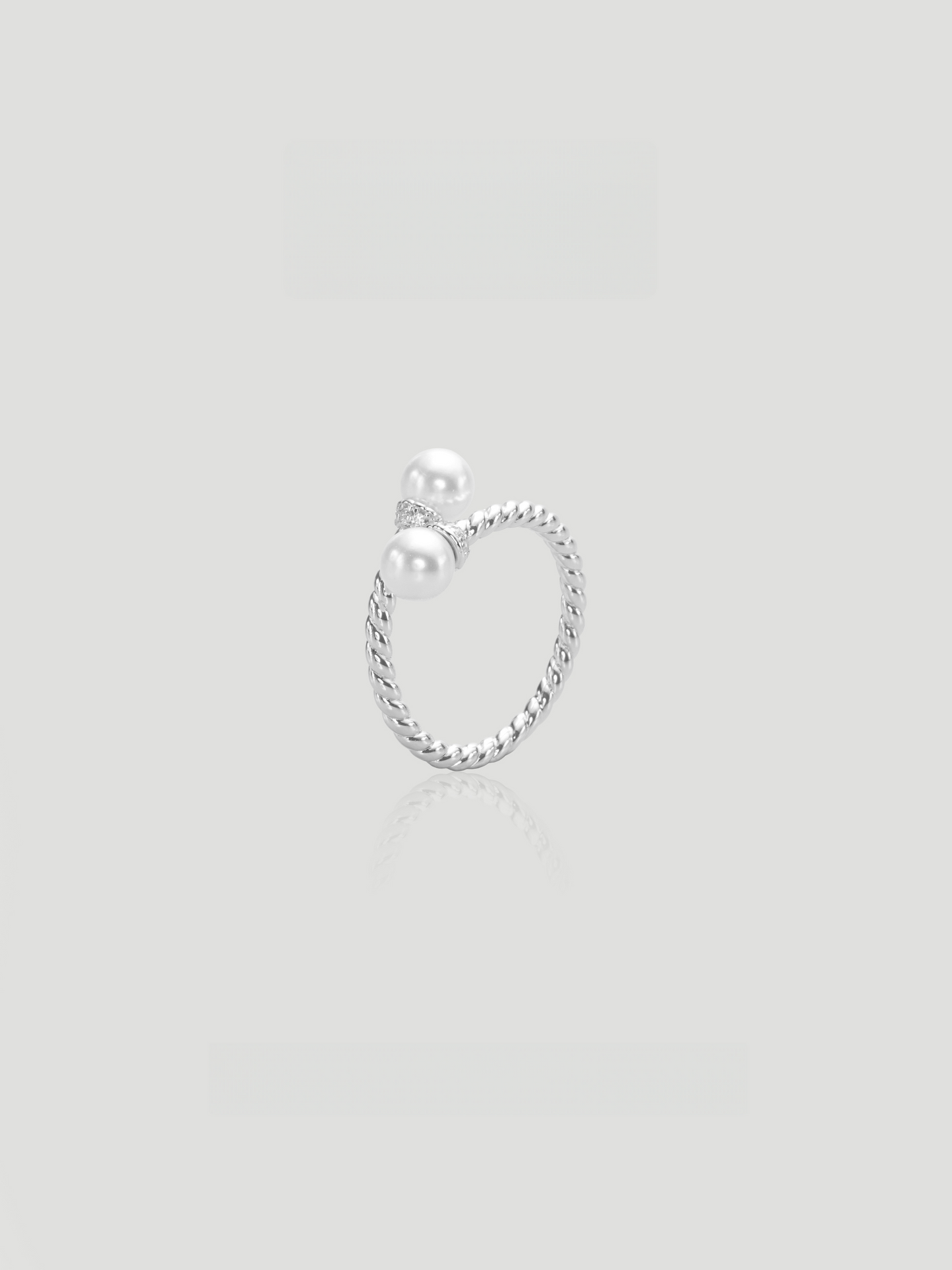 CARV. silver pearl twist ring with double pearl detail, rope-textured band and small stone accent
