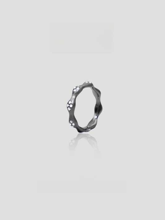 CARV. black flower ring with irregular petal band, crystal accents and dark metal finish