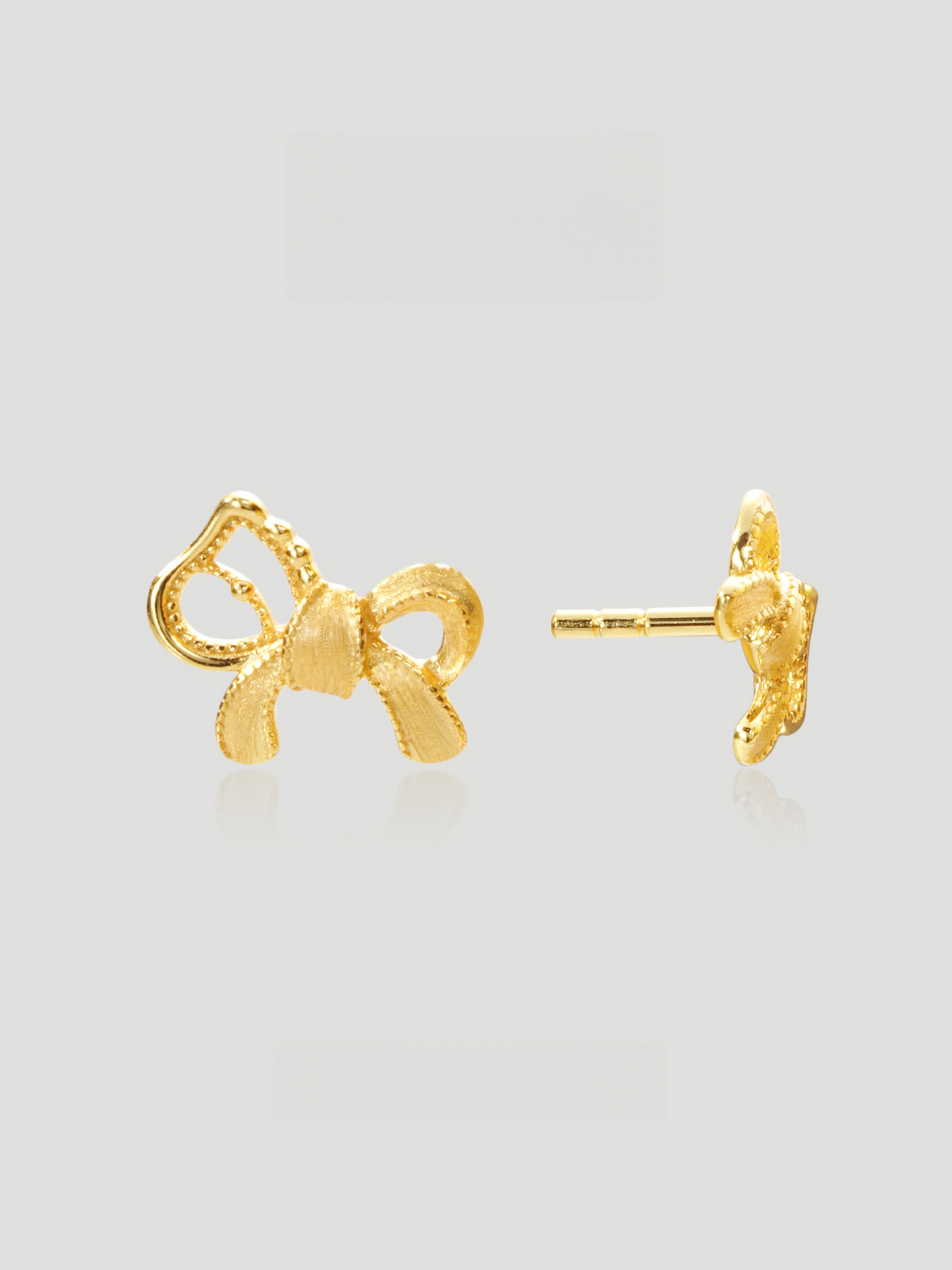 CARV. gold bow stud earrings with sculptural ribbon shape, pavé detail and polished post back