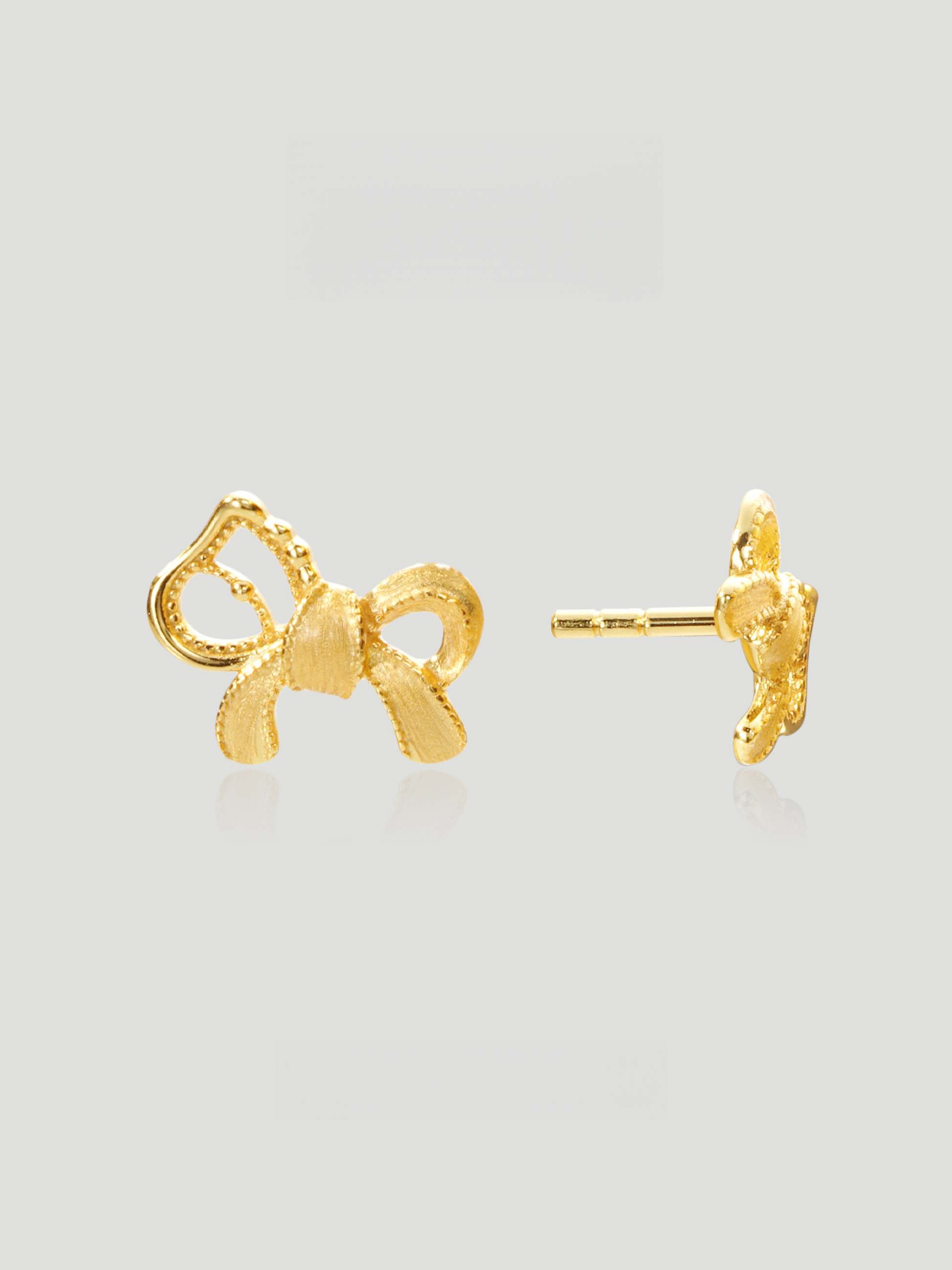 CARV. gold bow stud earrings with sculptural ribbon shape, pavé detail and polished post back