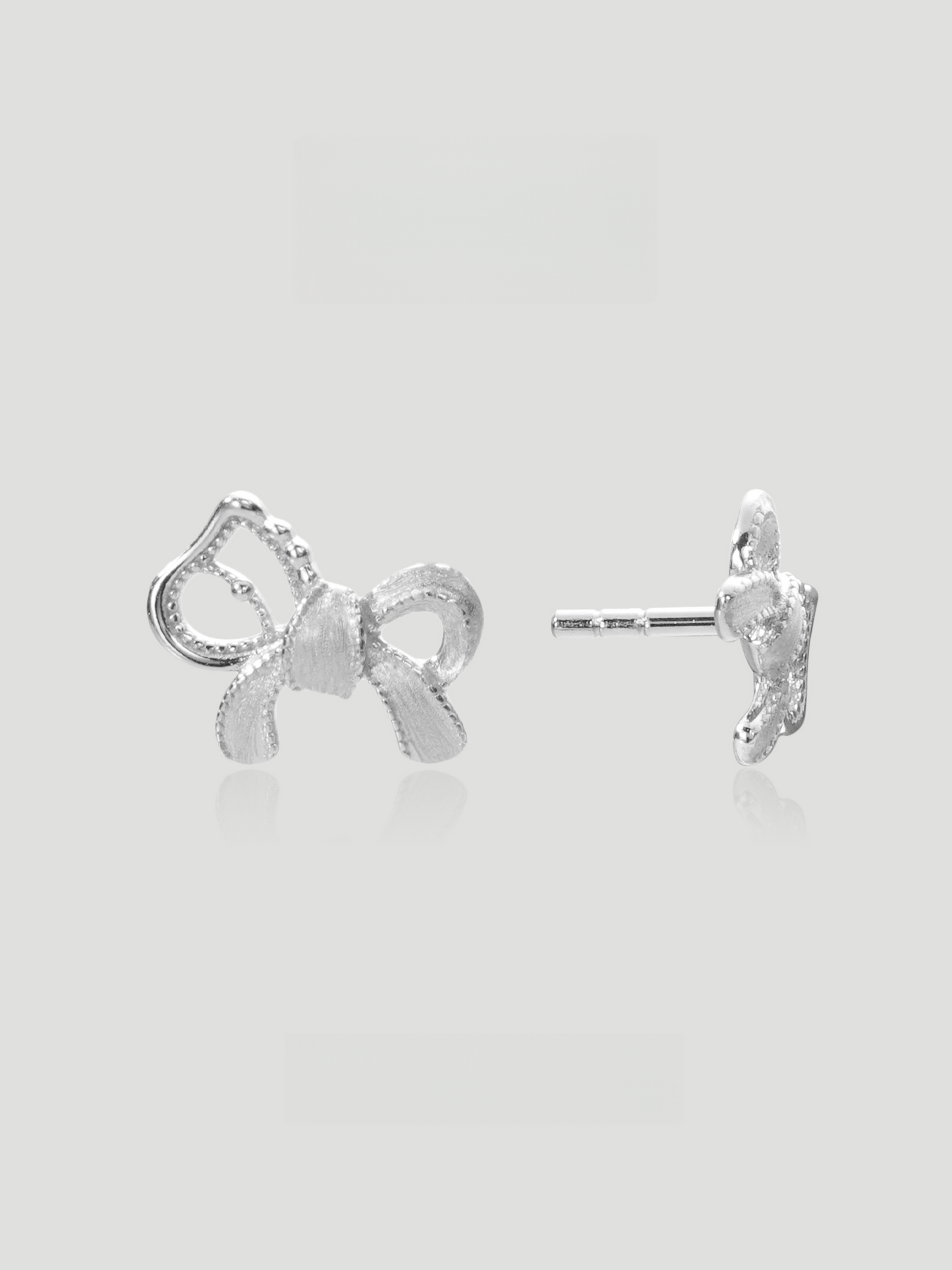 CARV. silver bow stud earrings with sculptural ribbon shape, pavé detail and polished post back