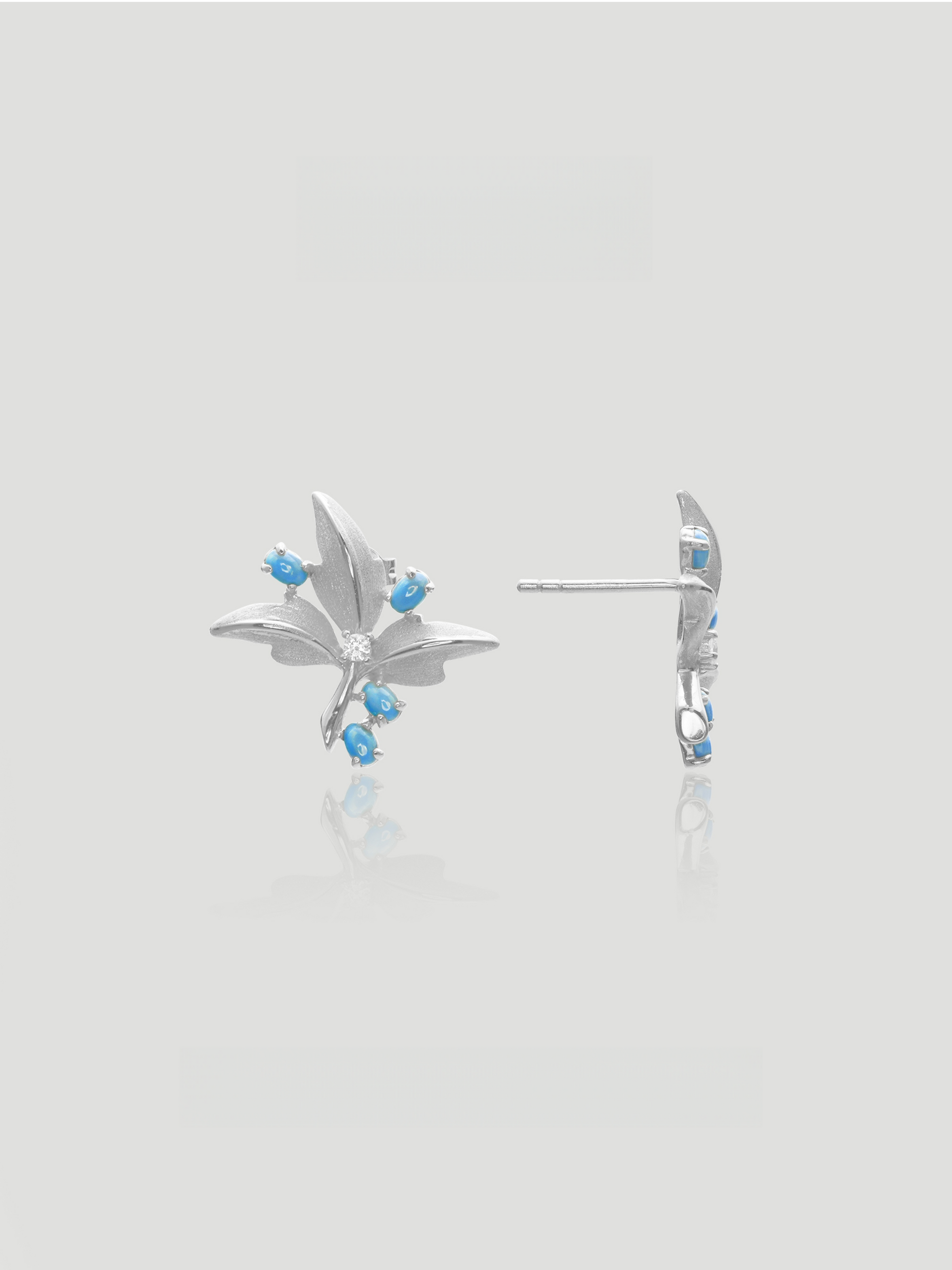 CARV. silver turquoise floral stud earrings with blue stone accents and crystal center, front and side view