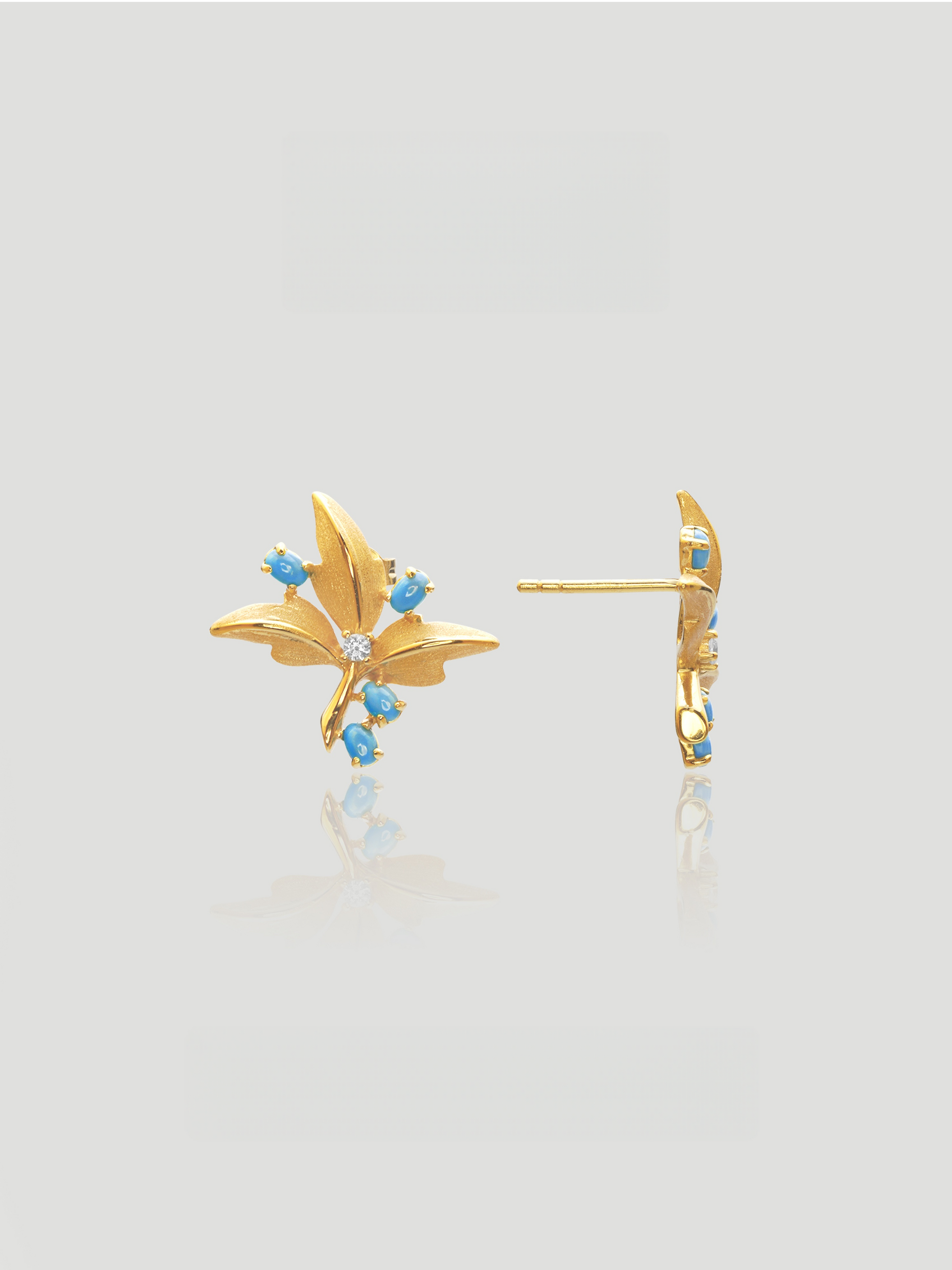 CARV. gold turquoise floral stud earrings with blue stone accents and crystal center, front and side view