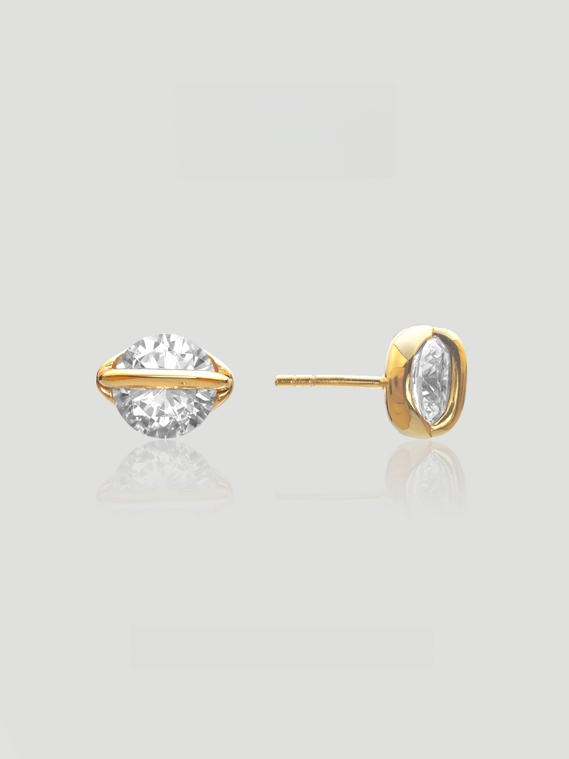 CARV. gold round crystal orbit stud earrings with large clear crystal, gold bezel setting and orbit bar detail