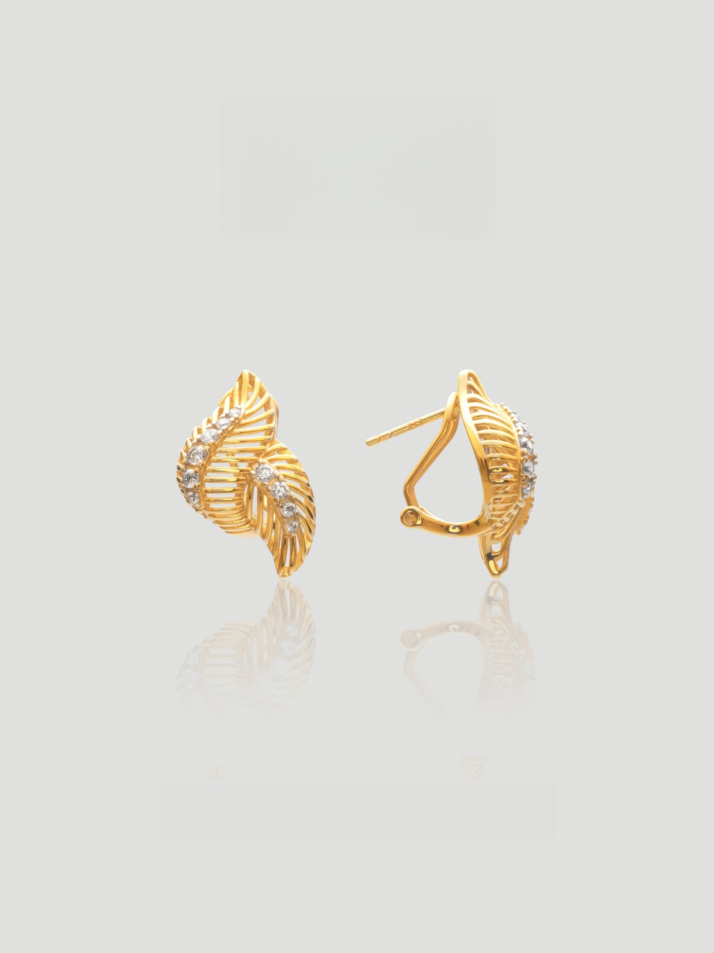 CARV. gold leaf pavé stud earrings with layered leaf shape and crystal detailing product close-up