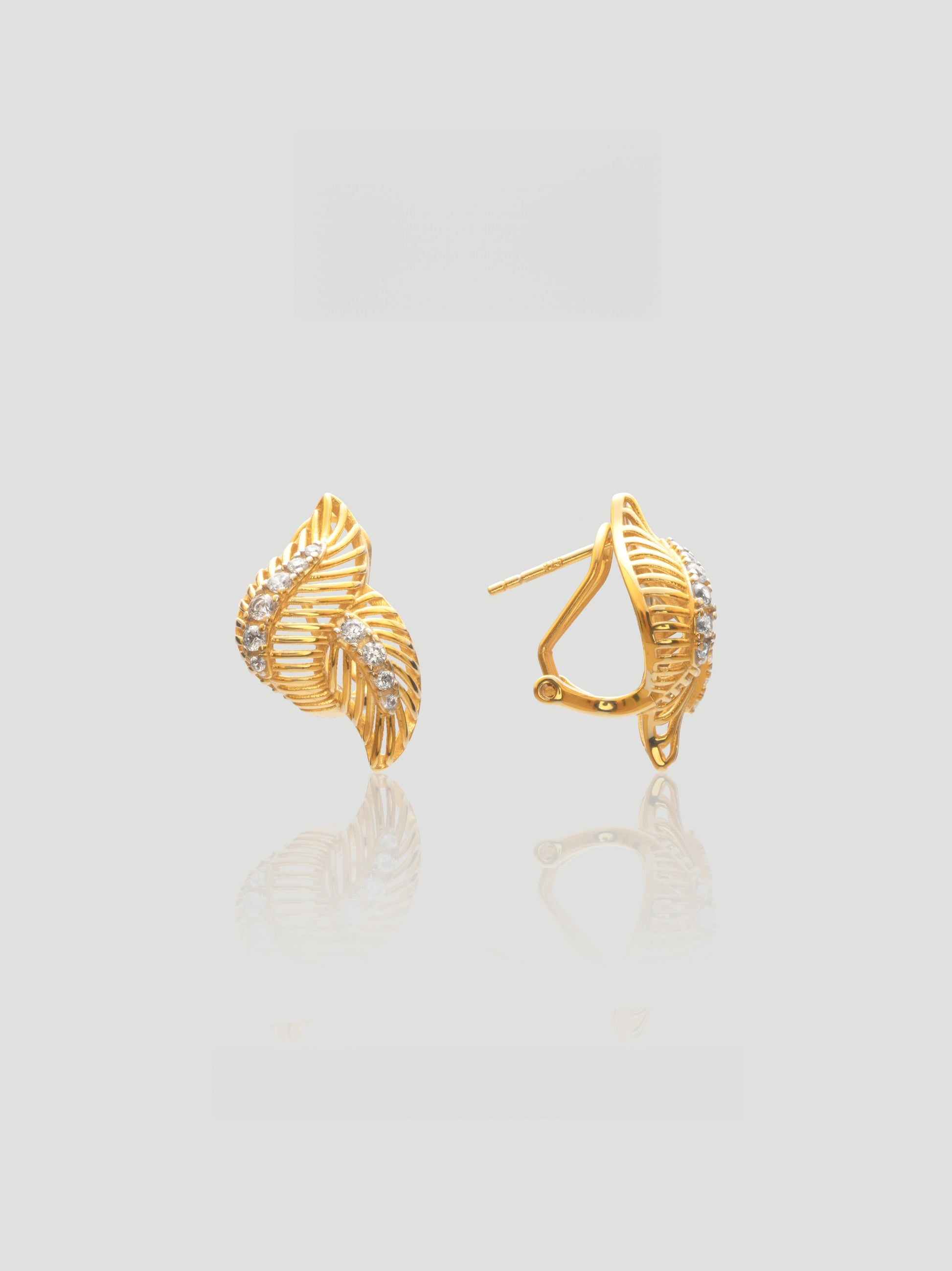 CARV. gold leaf pavé stud earrings with layered leaf shape and crystal detailing product close-up