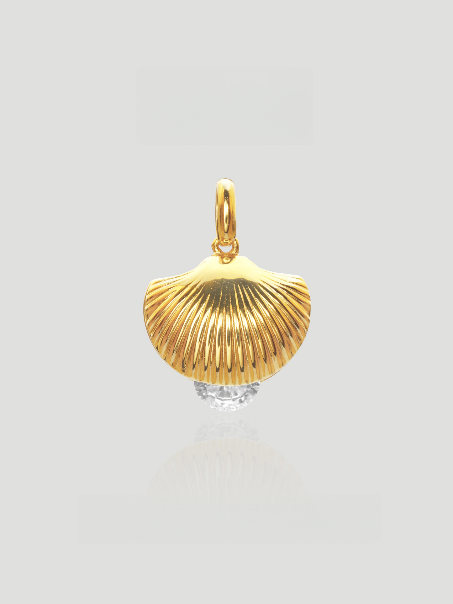 CARV. gold shell pendant necklace with textured fan shell charm and clear crystal accent product close-up