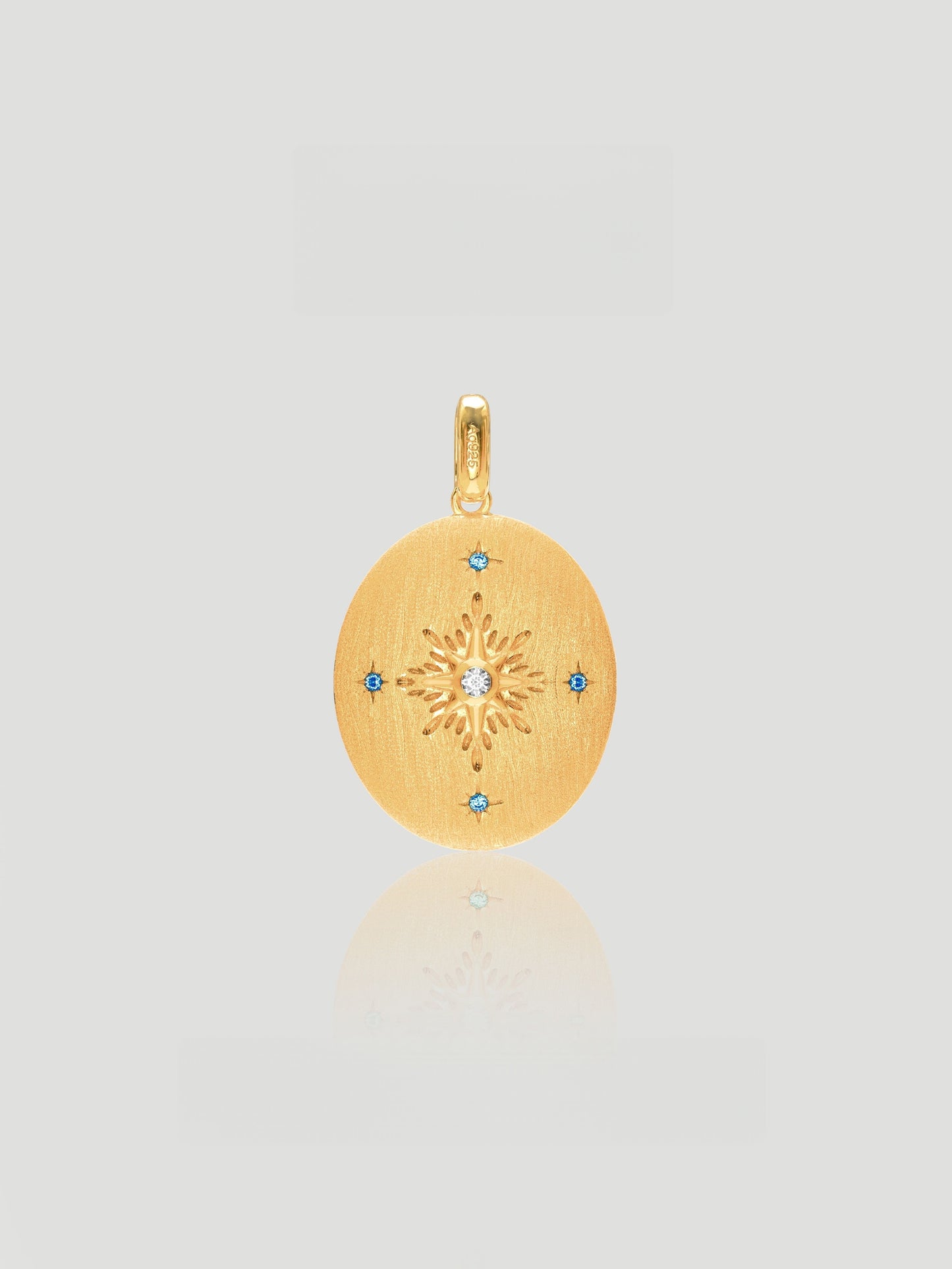 CARV. reversible celestial oval pendant necklace with gold back, starburst engraving and blue stone accents