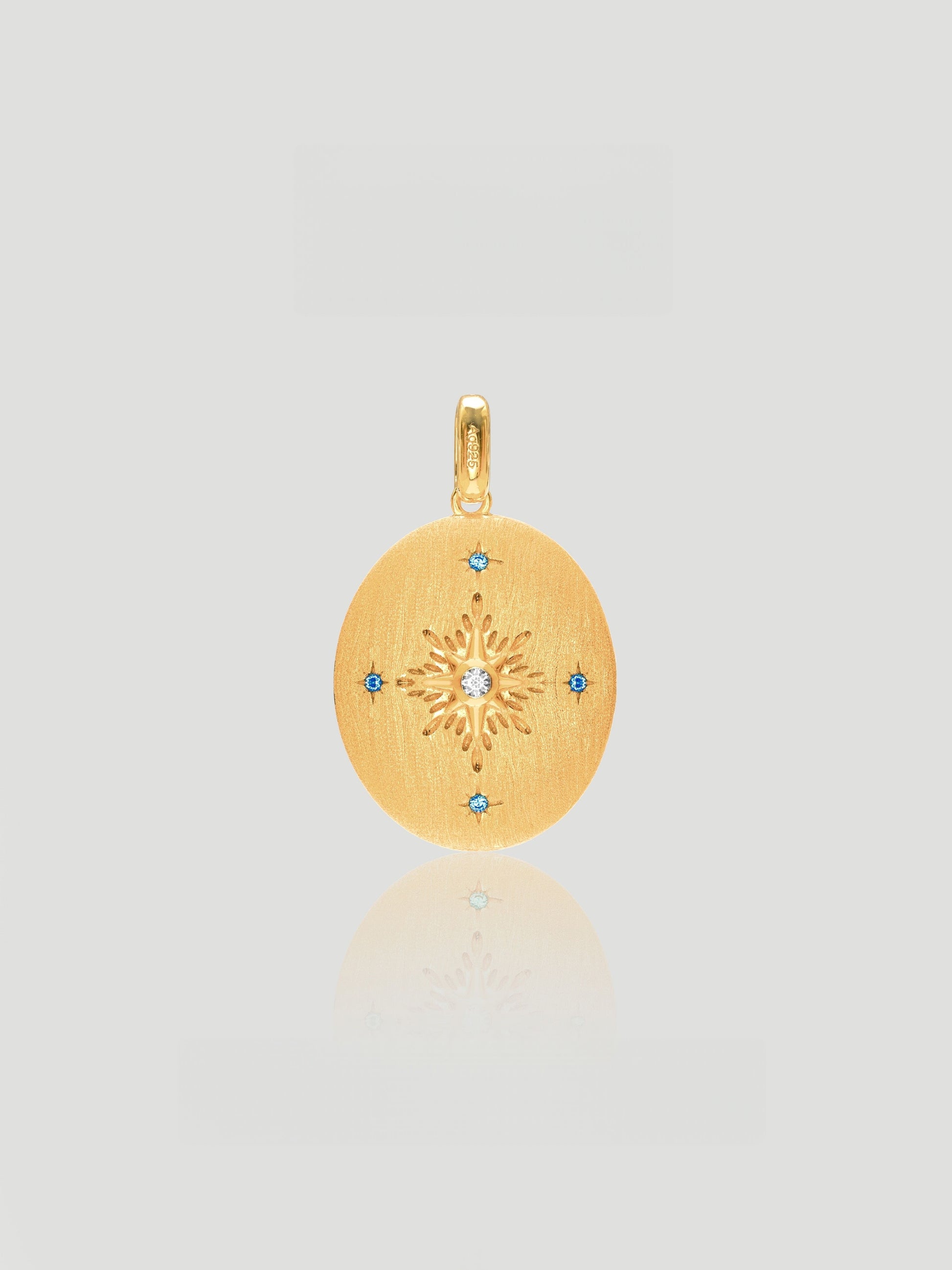 CARV. reversible celestial oval pendant necklace with gold back, starburst engraving and blue stone accents