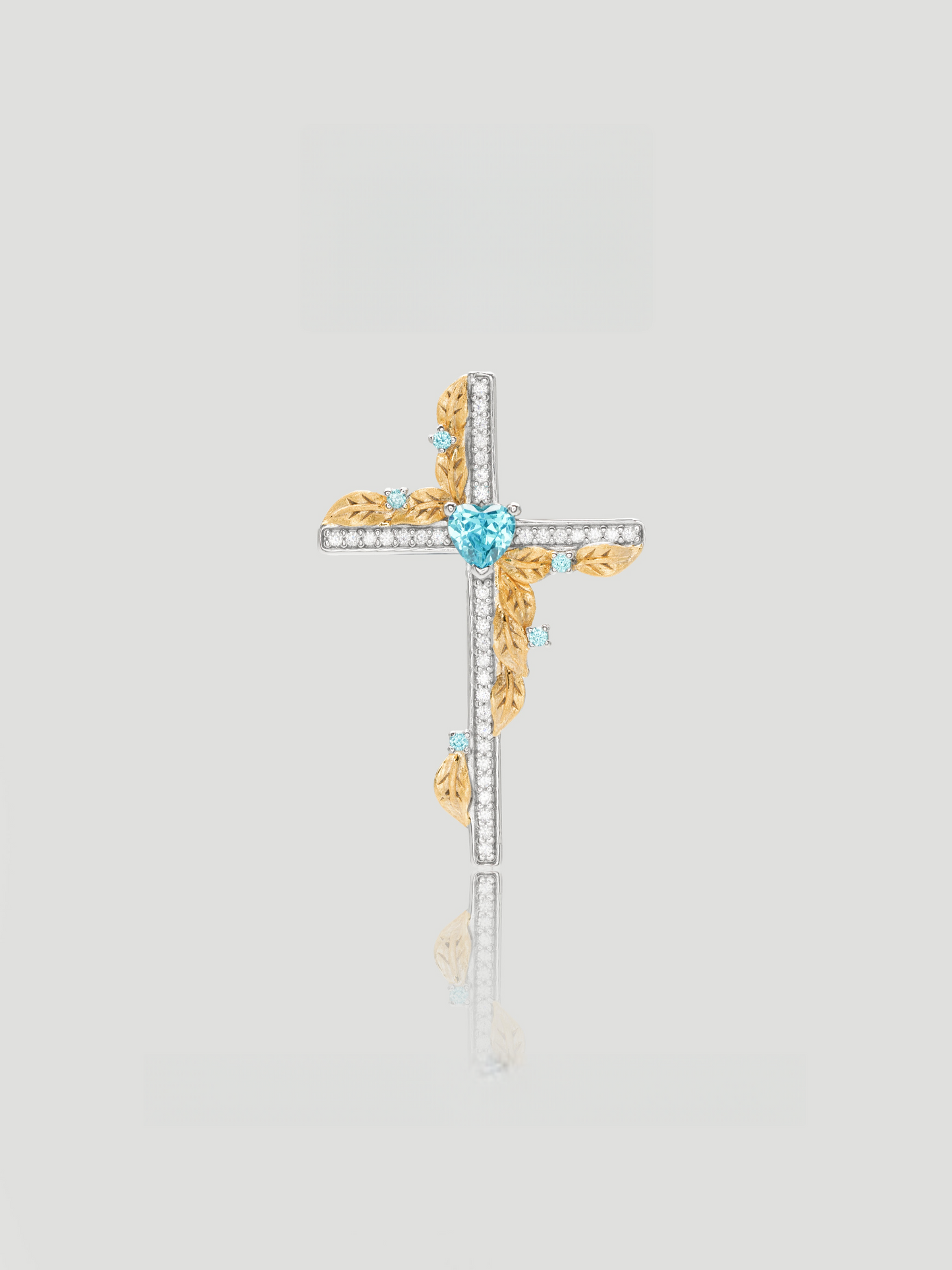 CARV. two-tone cross pendant necklace with blue heart stone, gold leaf accents and pavé cross detail product close-up