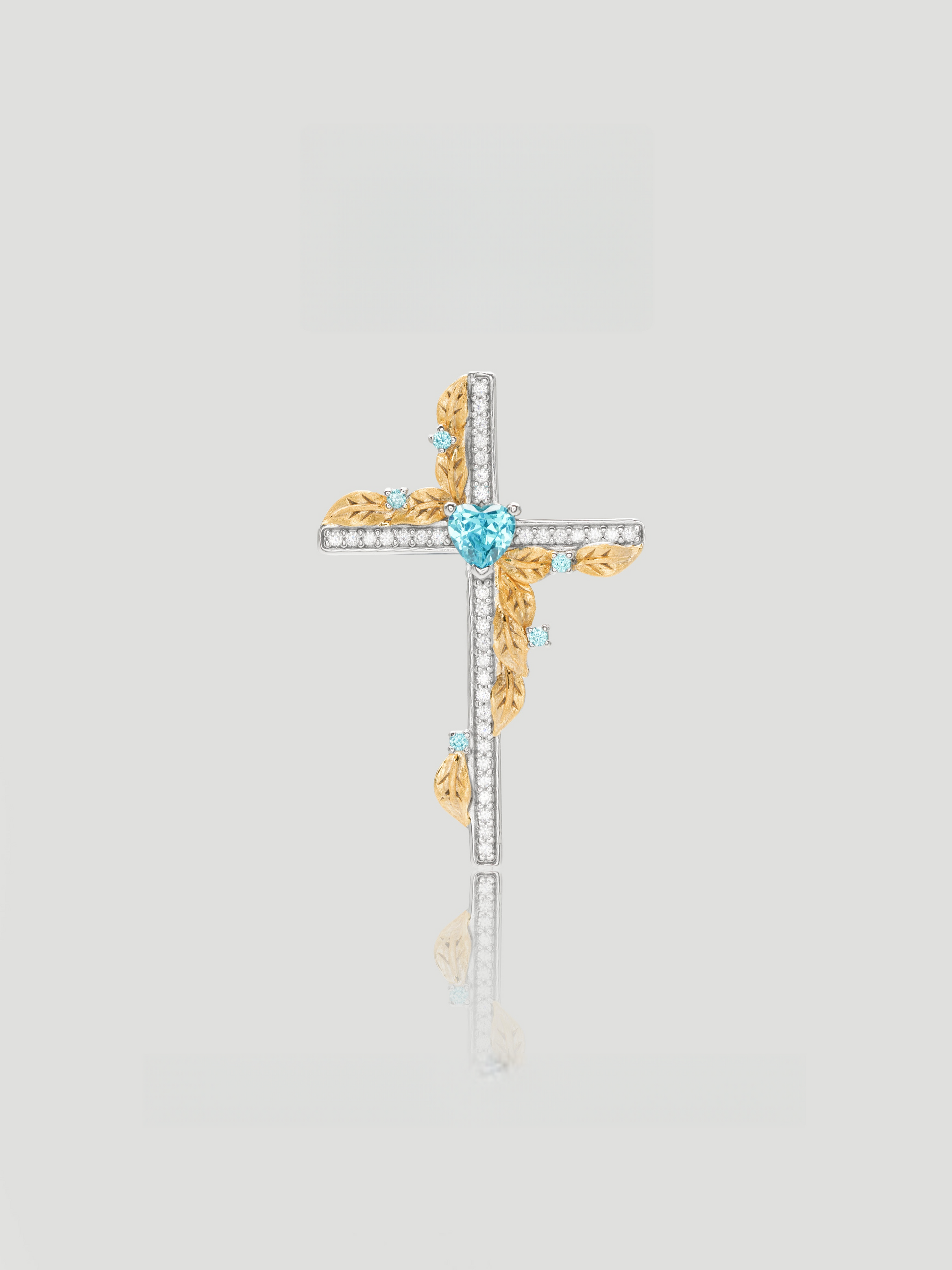 CARV. two-tone cross pendant necklace with blue heart stone, gold leaf accents and pavé cross detail product close-up