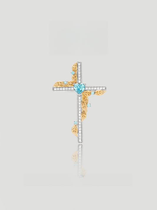 CARV. two-tone cross pendant necklace with blue heart stone, gold leaf accents and pavé cross detail product close-up
