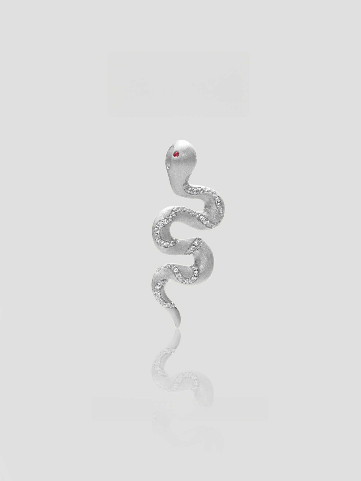 CARV. silver snake pendant necklace with textured serpent charm, fine chain and red eye detail