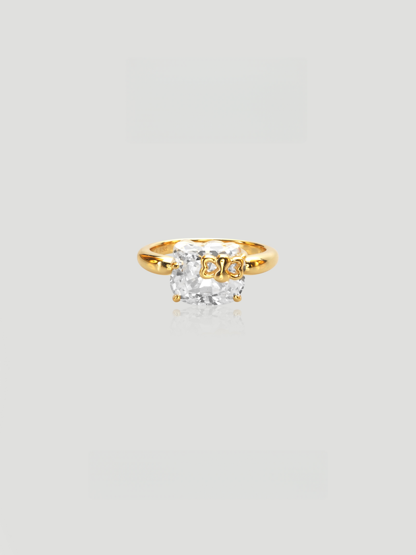 CARV. gold bow ring with cushion-cut stone and polished band detail