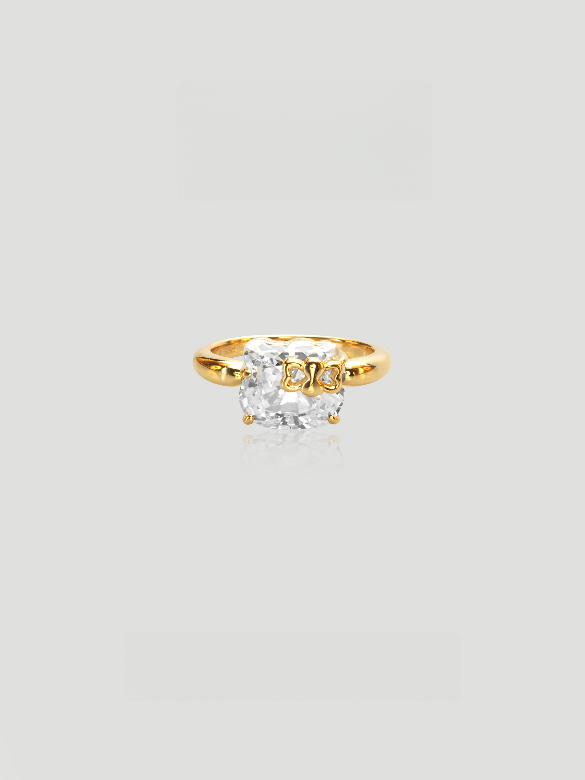 CARV. gold bow ring with cushion-cut stone and polished band detail
