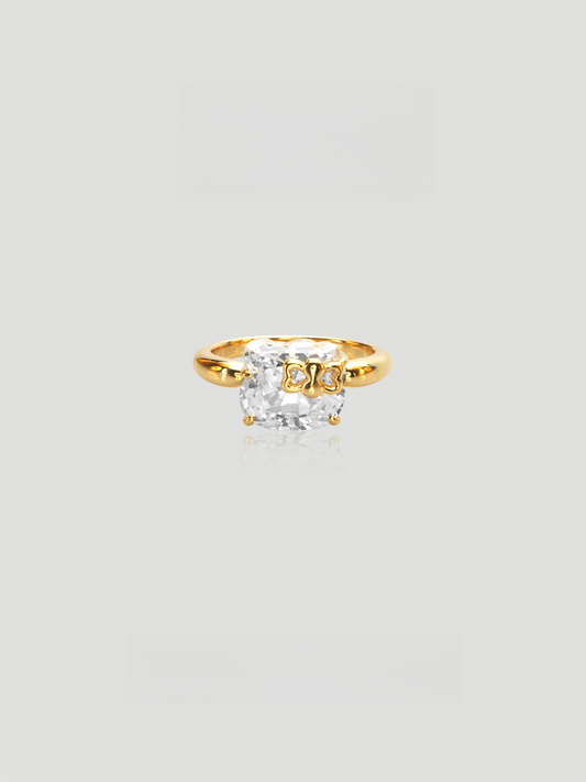 CARV. gold bow ring with cushion-cut stone and polished band detail
