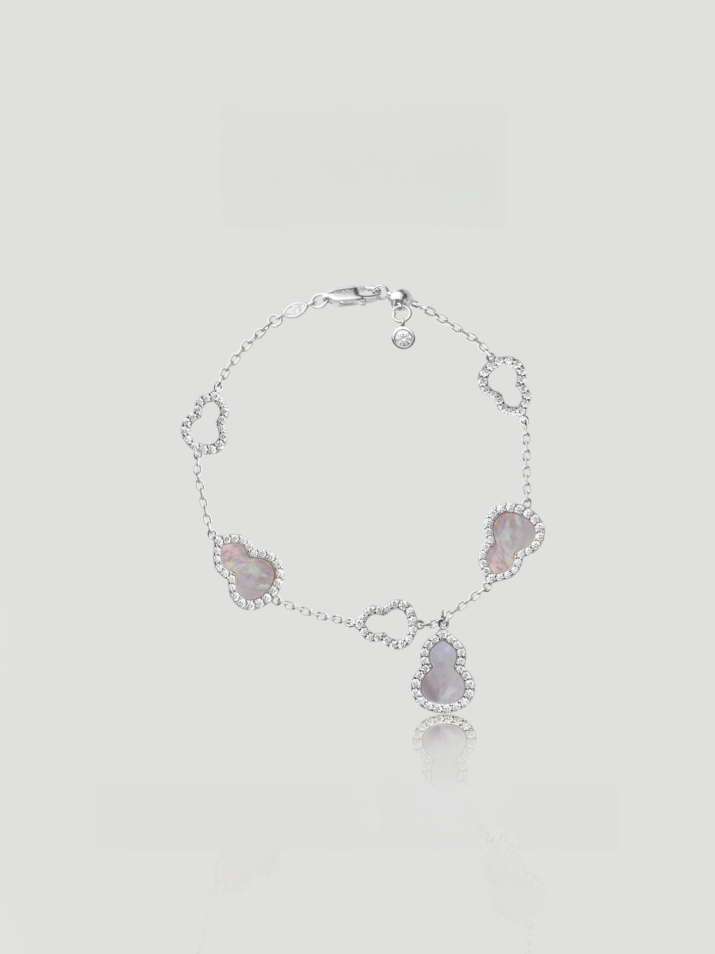 CARV. silver gourd charm bracelet with pink stone details and halo-set drop charm product close-up