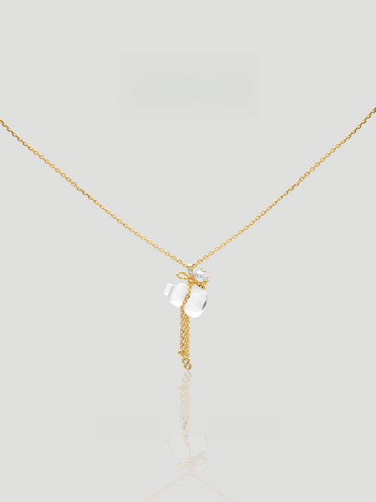CARV. gold pendant necklace with white crystal charm, floral top detail and tassel drop product close-up