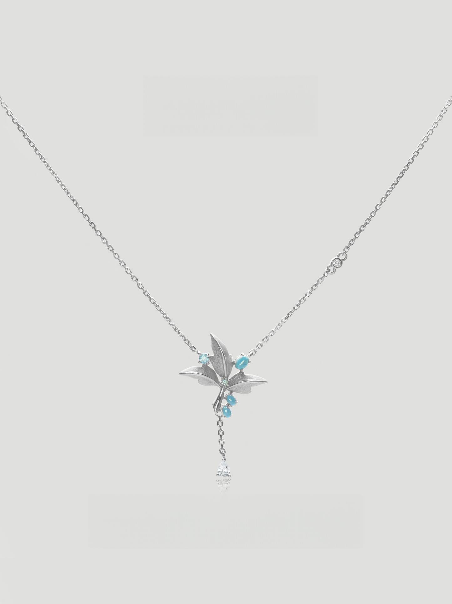 CARV. silver lily pendant necklace with turquoise accent, fine chain and delicate tassel drop