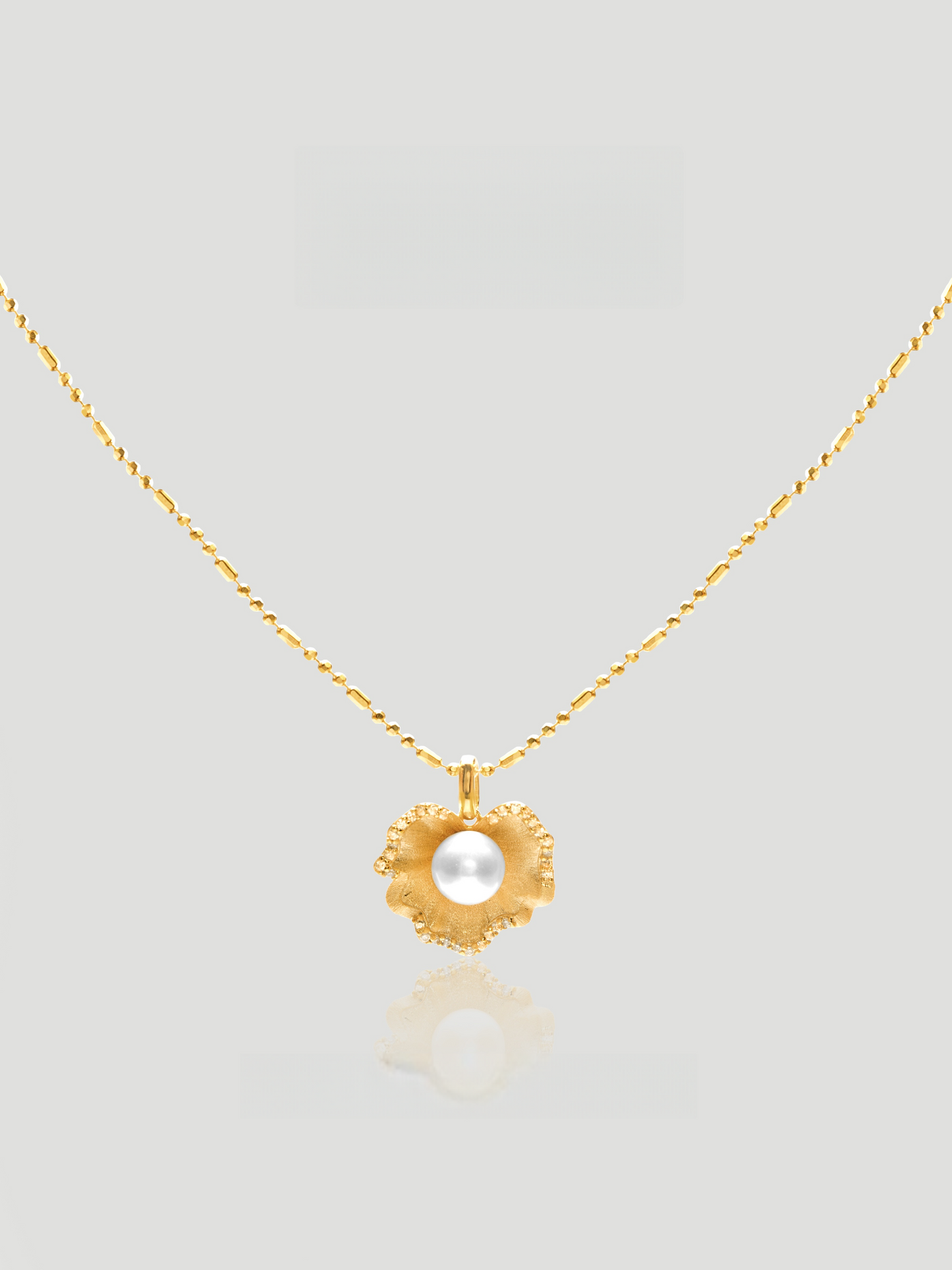 CARV. gold pearl flower pendant necklace with sculptural petal charm and round pearl centre