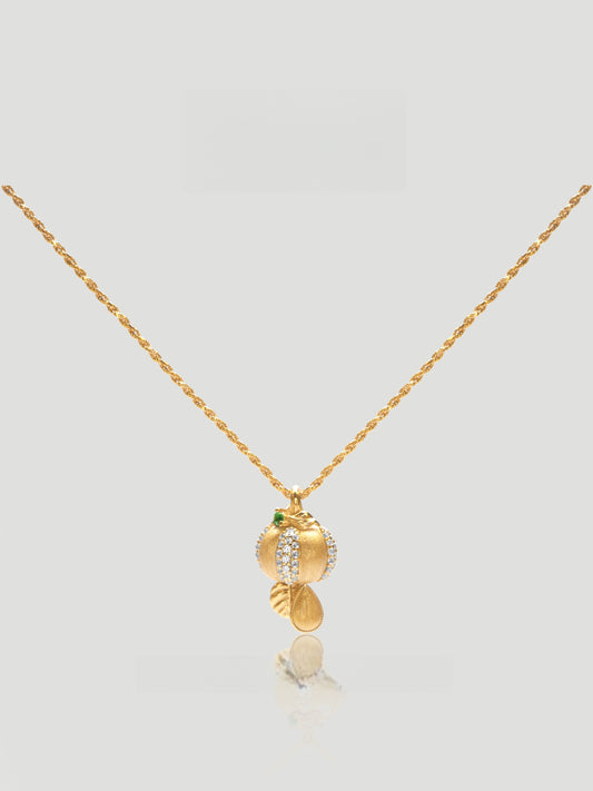 CARV. gold pumpkin pendant necklace with green stone accent and textured round drop charm product close-up