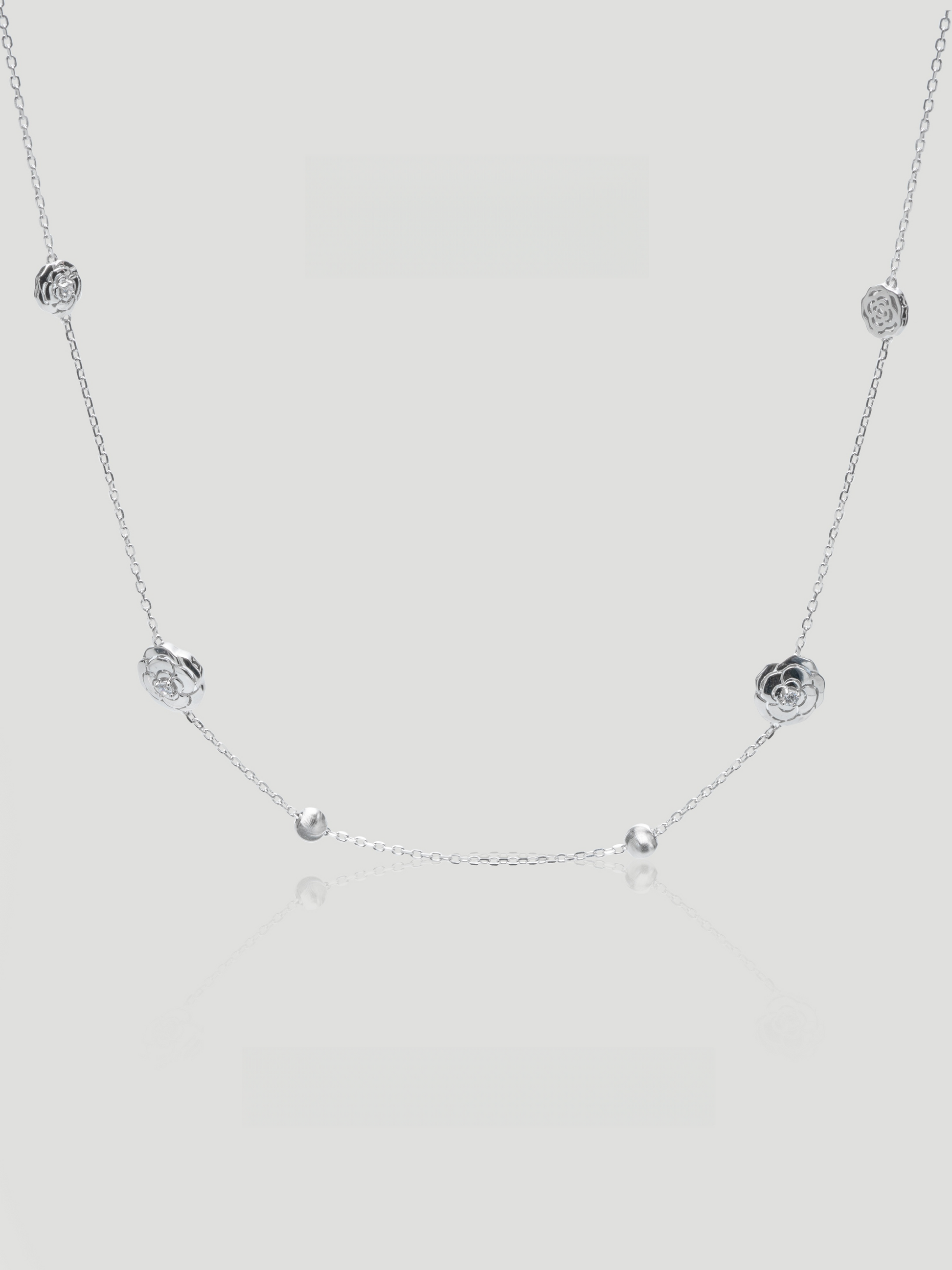CARV. silver rose station necklace with floral bead stations, fine chain and polished round accents