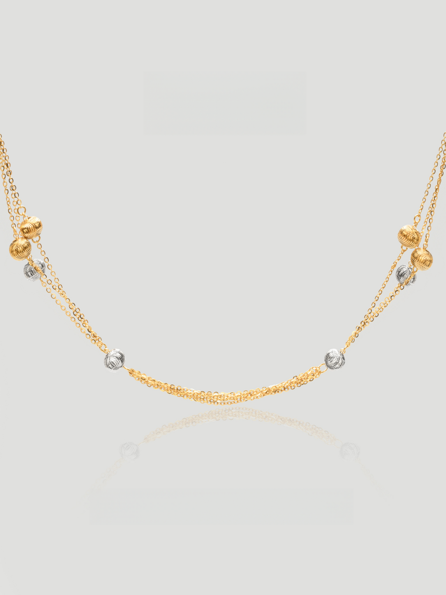 CARV. gold layered bead necklace with silver bead accents and double chain design