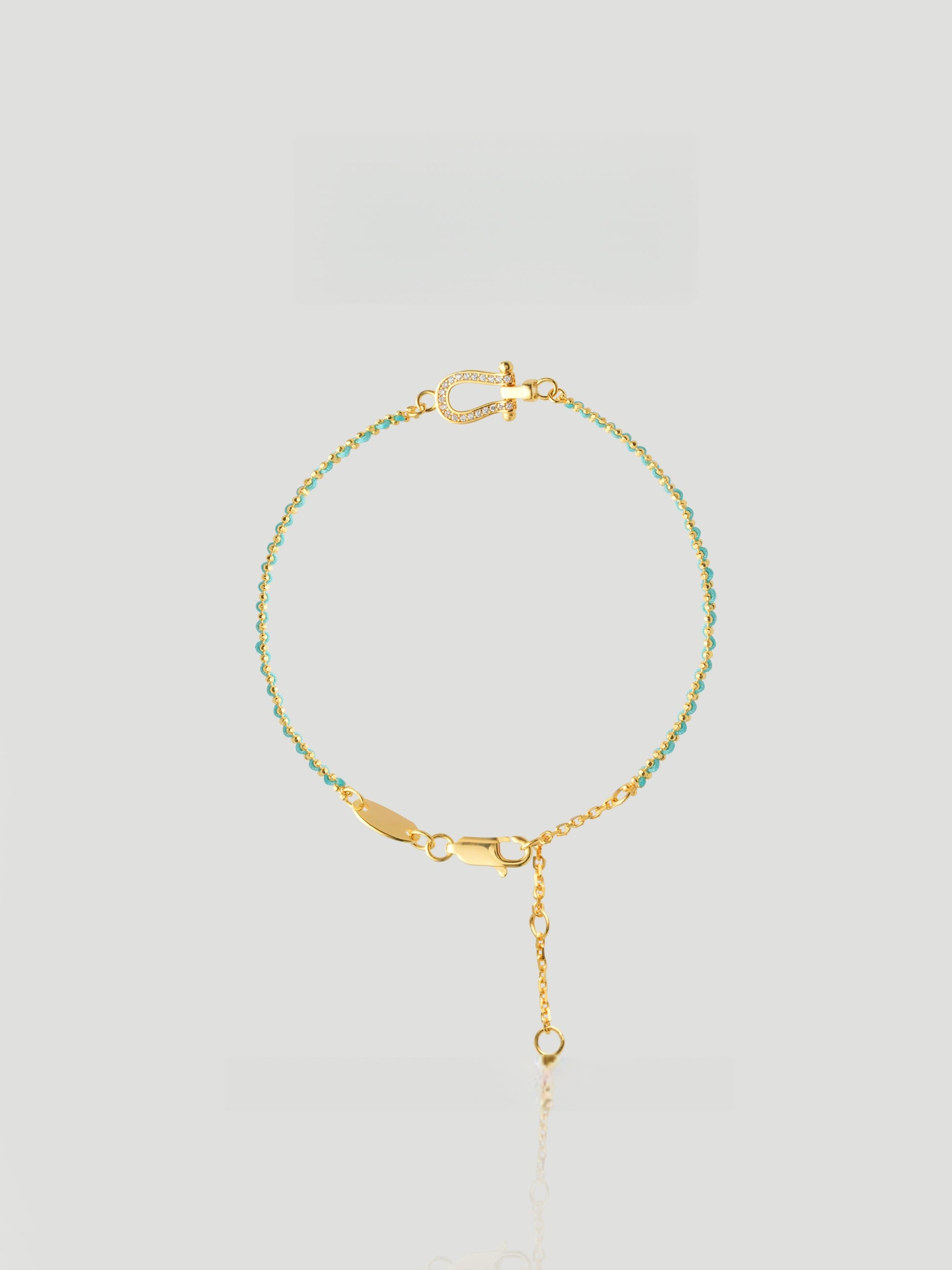 CARV. turquoise beaded bracelet with gold bar accent, fine chain and adjustable drop detail