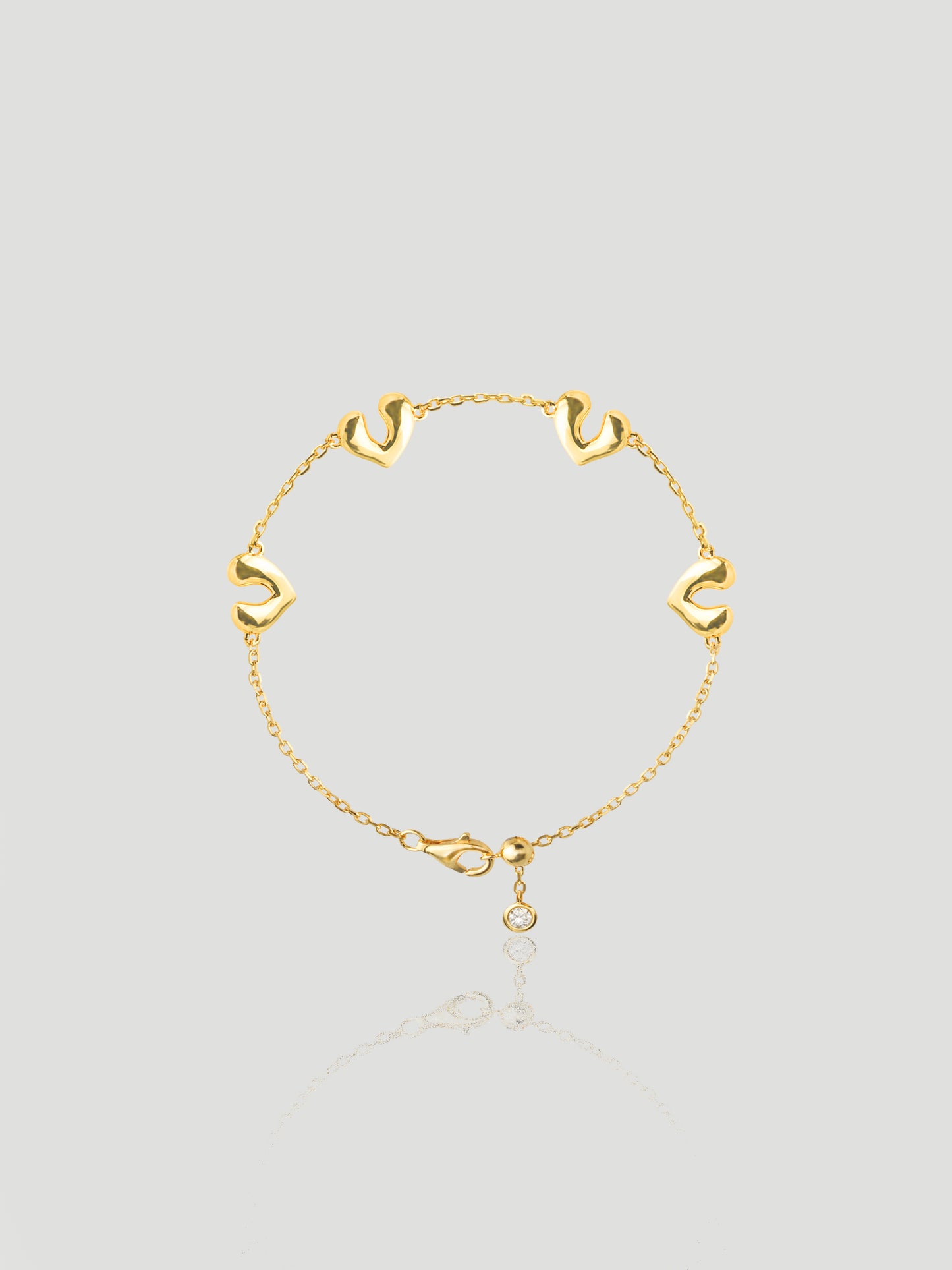 CARV. gold open heart charm bracelet with delicate chain links and a round drop charm