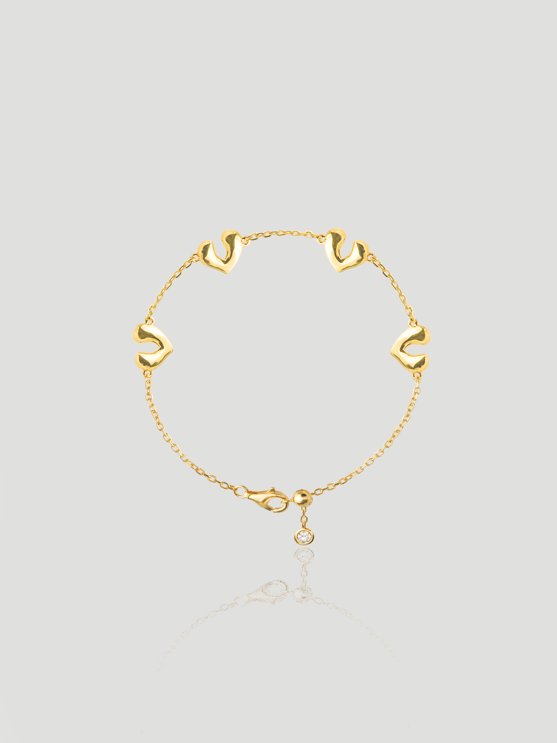 CARV. gold open heart charm bracelet with delicate chain links and a round drop charm