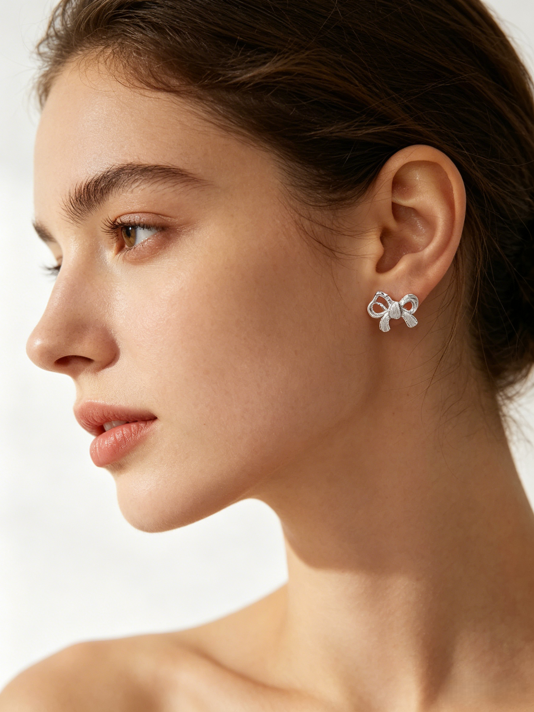 CARV. silver bow stud earrings with sculptural ribbon shape, pavé detail and polished post back