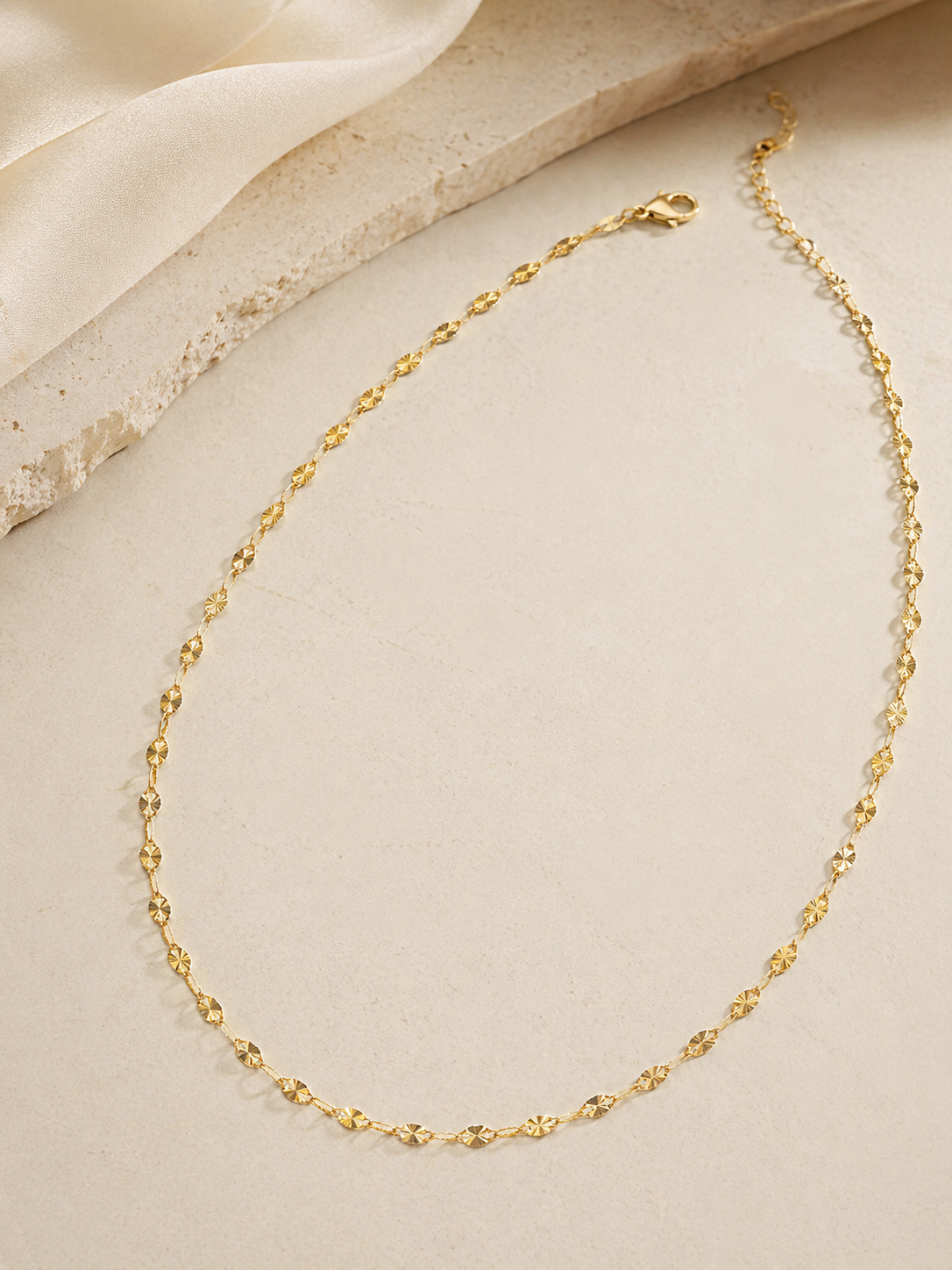 CARV. gold facet single chain necklace with elongated faceted links studio flatlay
