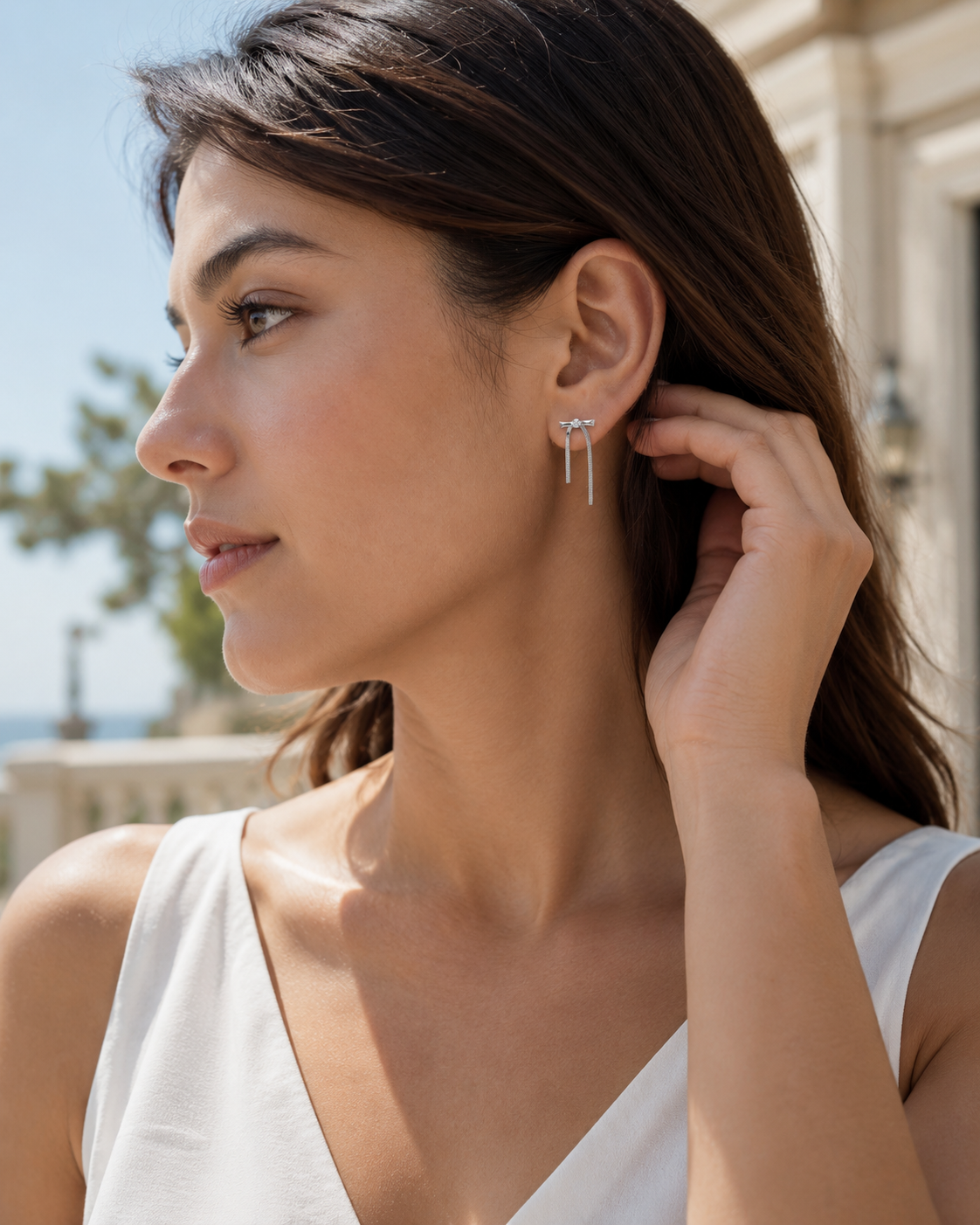 CARV. silver bar drop earrings worn on ear with slim drop bars and crystal stud setting