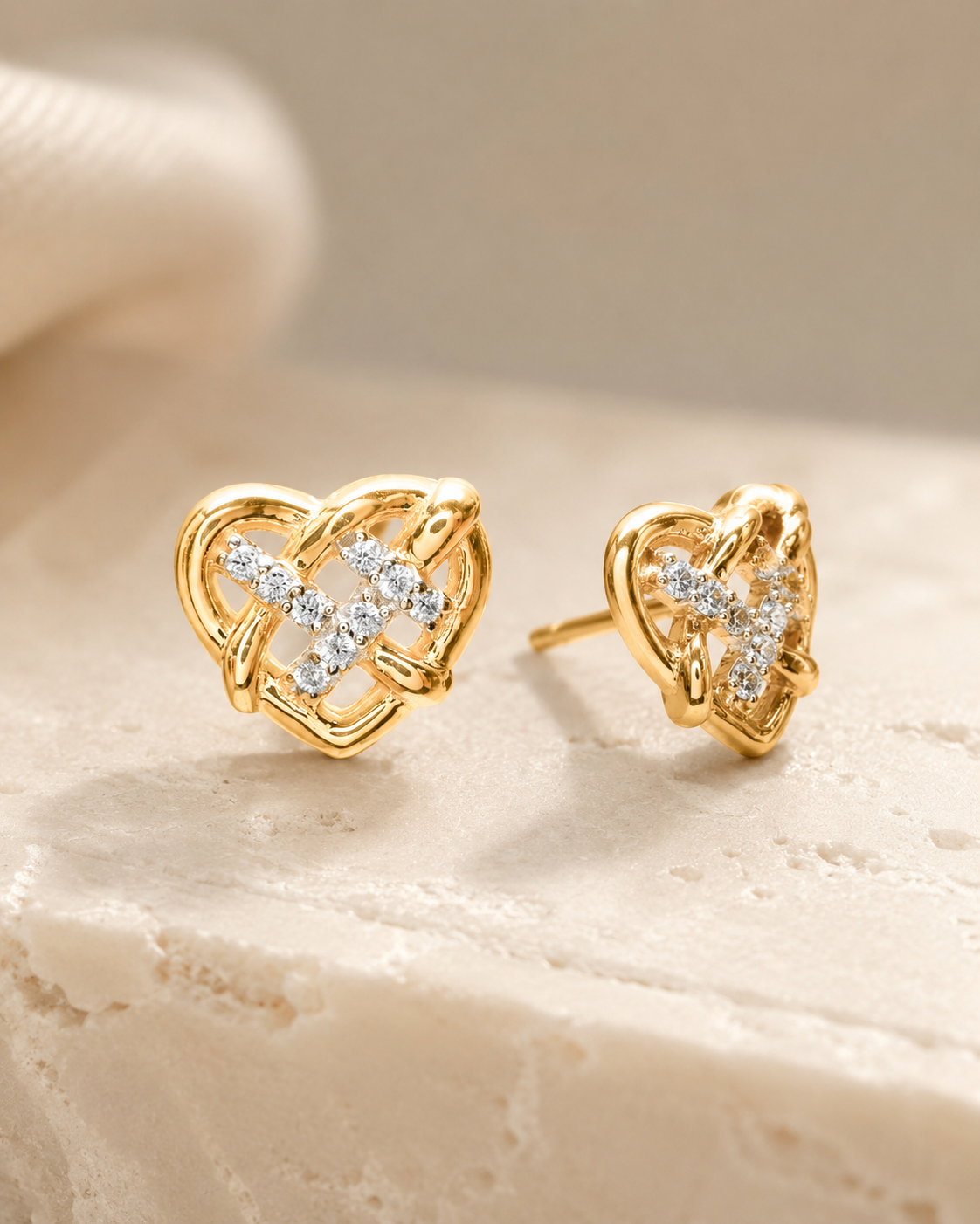 CARV. gold heart stud earrings with crystal knot detail and pavé stone setting product display